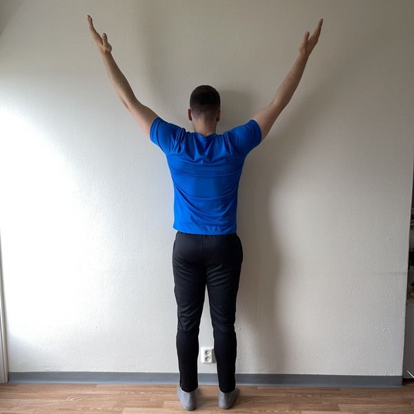 fix rounded shoulders with exercises - wall pull Y