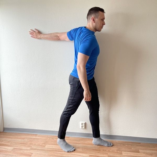 standing chest stretch against the wall