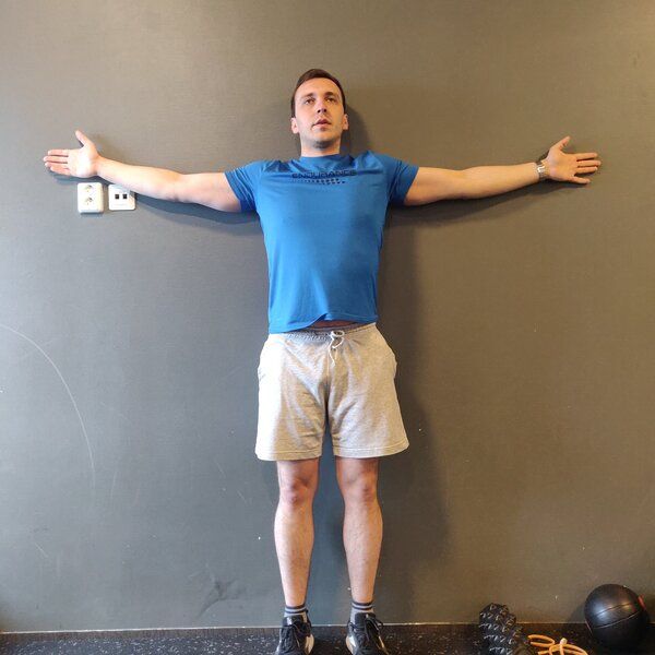 standing arm press against the wall